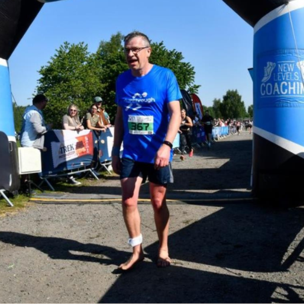 Barefoot runner taking on the Cross Bay Half-Marathon
