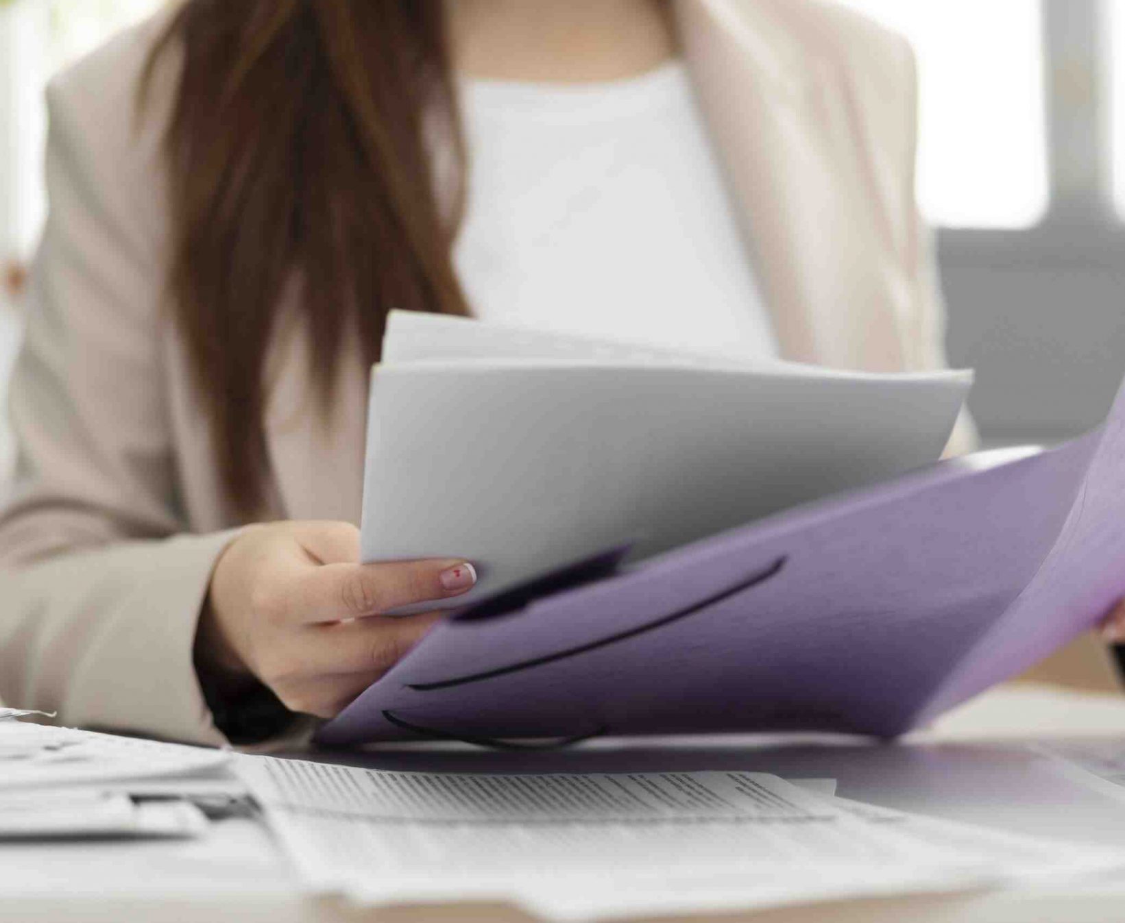 Young adult organizing documents scaled